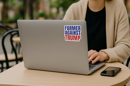 'Farmer Against Trump' magnet or vinyl decal displayed on the back of a laptop. A bold, high-quality political sticker perfect for cars, laptops, fridges, or toolboxes. Great for activists, protestors, or anyone fed up with fascism.