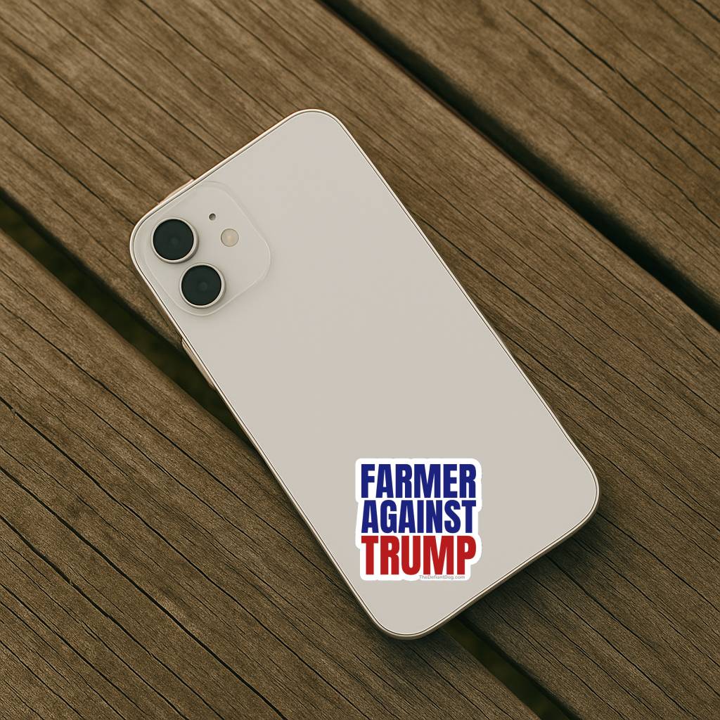 White smartphone with 'Farmer Against Trump' sticker on a wooden surface