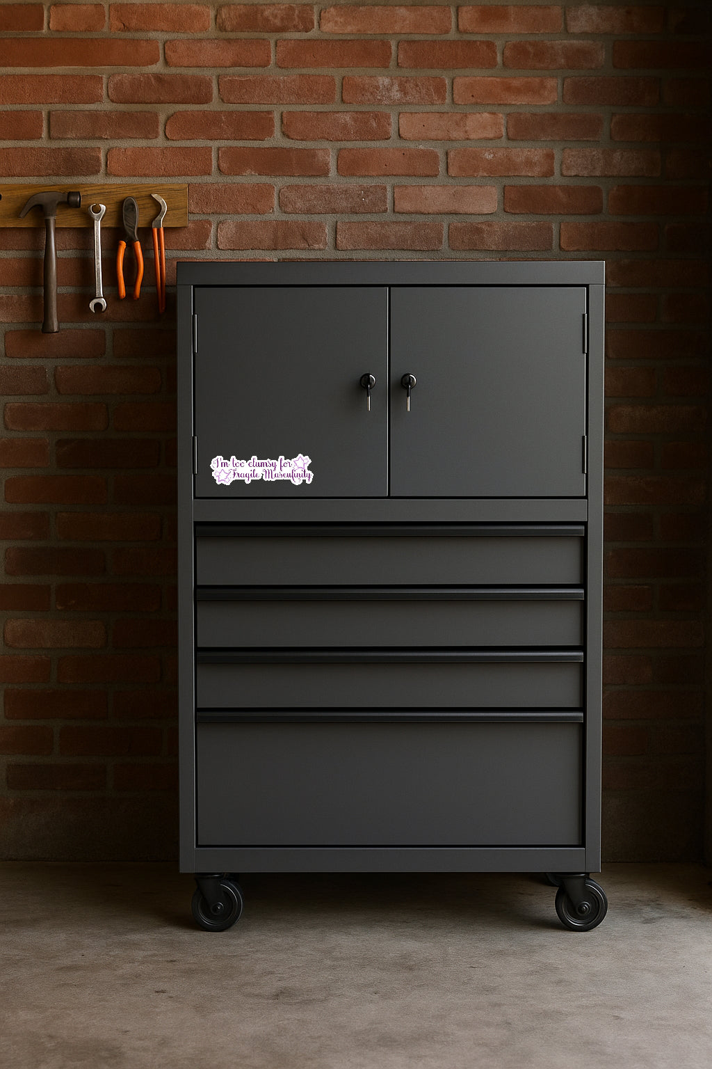 I'm Too Clumsy for Fragile Masculinity' magnet or vinyl decal displayed on a black tool cabinet. A bold, high-quality political sticker perfect for cars, laptops, fridges, or toolboxes. Great for activists, protestors, or anyone fed up with fascism.