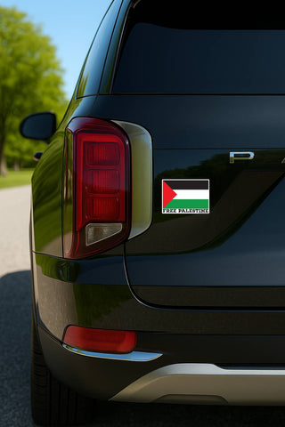 A rectangular Palestine flag decal sticker with 'FREE PALESTINE' text, shown applied to the rear quarter panel of a black SUV.