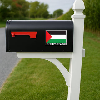 A black mailbox mounted on a white post outdoors, featuring a Palestine flag decal with the text 'FREE PALESTINE' on the front.