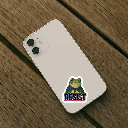 Phone case with a frog design and 'RESIST' text on a wooden surface