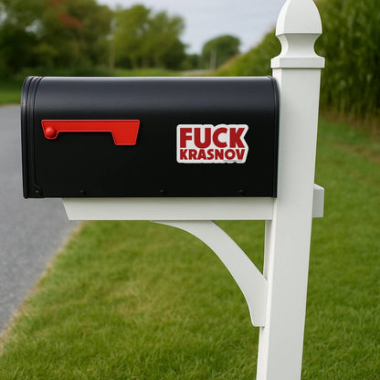 A black roadside mailbox with the Fuck Krasnov sticker applied to the side panel. The bold red text pops against the dark surface, demonstrating outdoor visibility and weather-resistant appeal.