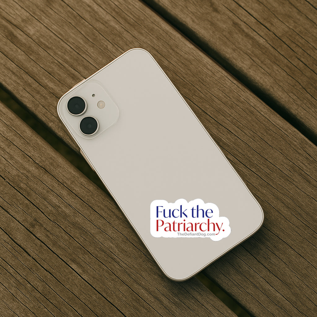 Phone with 'Fuck the Patriarchy' sticker on a wooden surface