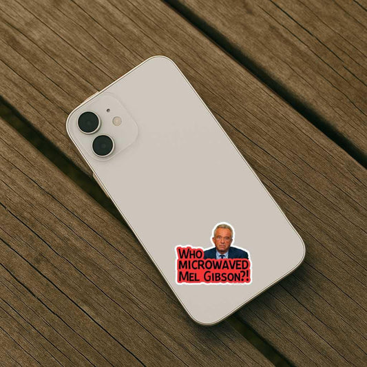 Phone case with a sticker of a man and text 'WHO MICROWAVED MEL GIBSON?' on a wooden surface
