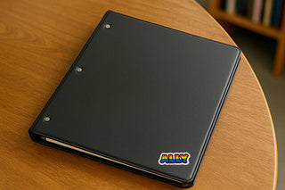 Black notebook with 'ALLY' logo on a wooden surface