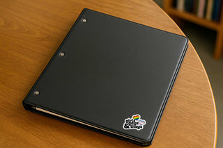 Black notebook with a logo on a wooden surface