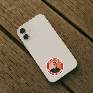 Phone case with a sticker of a person and text on a wooden surface