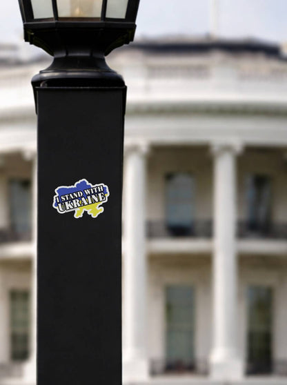 I Stand With Ukraine vinyl sticker on black lamp post with White House background, Ukraine flag country shape decal, pro Ukraine political bumper sticker, support Ukraine waterproof outdoor activist sticker