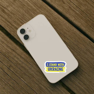 Phone with 'I Stand with Ukraine' sticker on a wooden surface