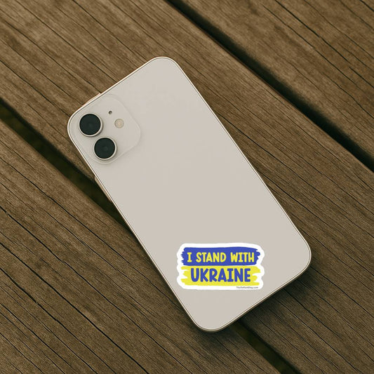 Phone with 'I Stand with Ukraine' sticker on a wooden surface