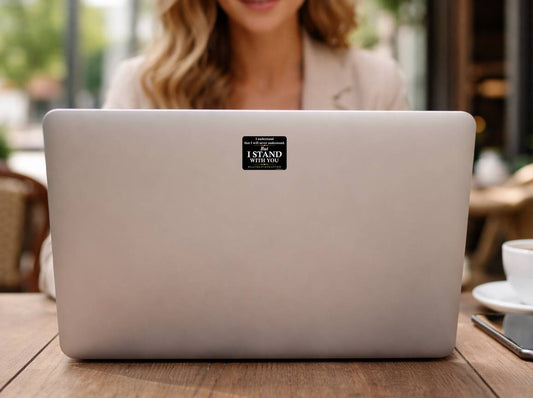 I Stand With You Black Lives Matter political sticker on laptop computer in cafe setting