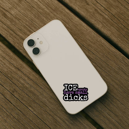 White smartphone with a sticker on a wooden surface