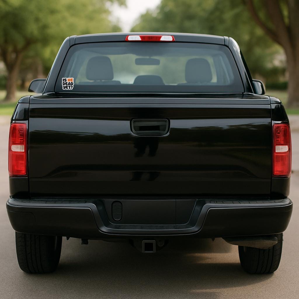 Black pickup truck parked on a road with trees in the background