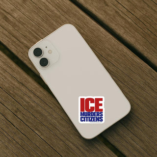 Phone with 'ICE Murders Citizens' sticker on a wooden surface