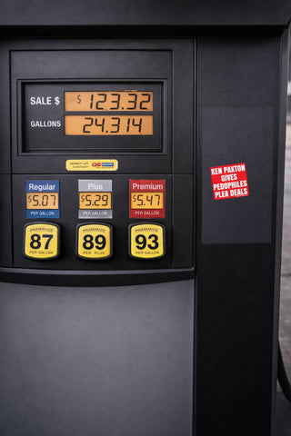 Close-up of a black gas pump display showing sale price, gallons, and fuel options 87, 89, and 93, with a red promotional sticker on the side.