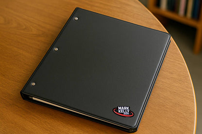Black notebook with a logo on a wooden table