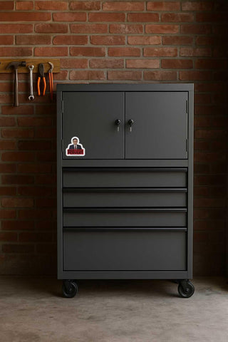 Dark gray tool cabinet with multiple drawers against a brick wall.