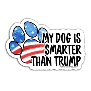 Sticker with American flag paw print and text 'My dog is smarter than Trump' on a white background
