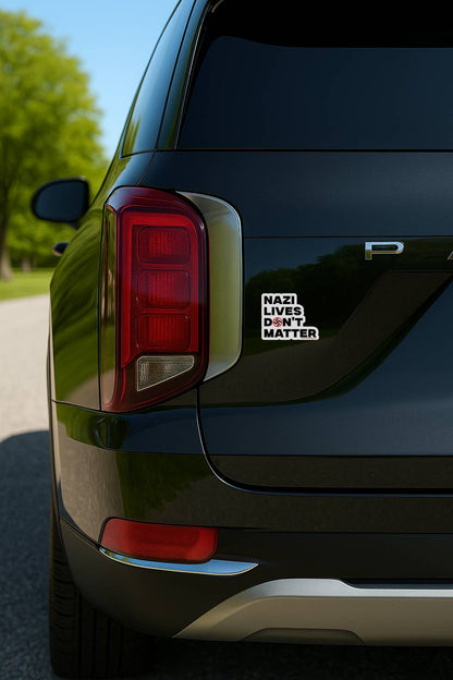 Nazi Lives Don’t Matter anti fascist vinyl car sticker on black SUV tailgate near taillight close detail outdoor setting