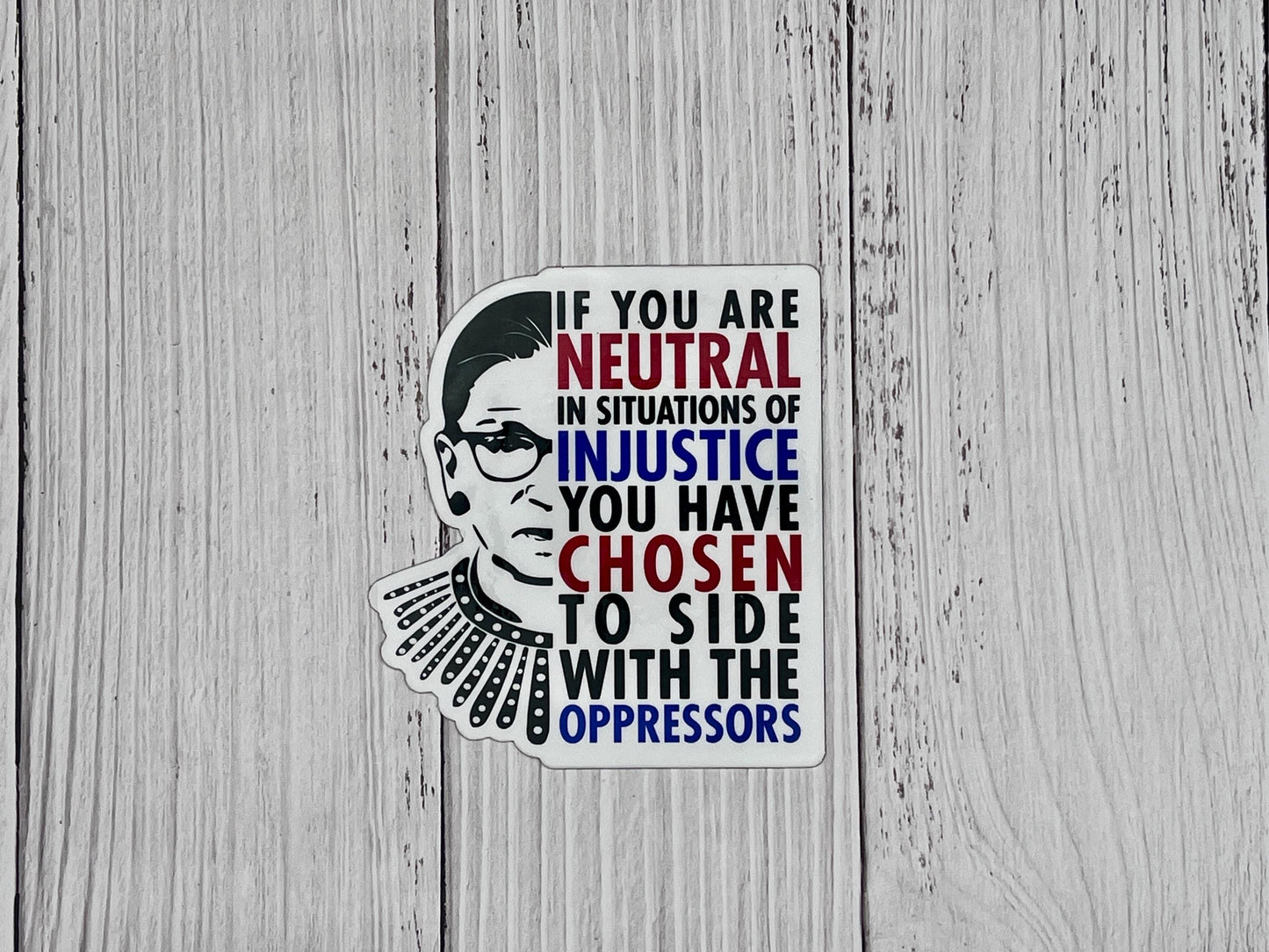 If you are neutral in situations of injustice, you have chosen to side with the oppressor magnet displayed on a table promoting action over silence