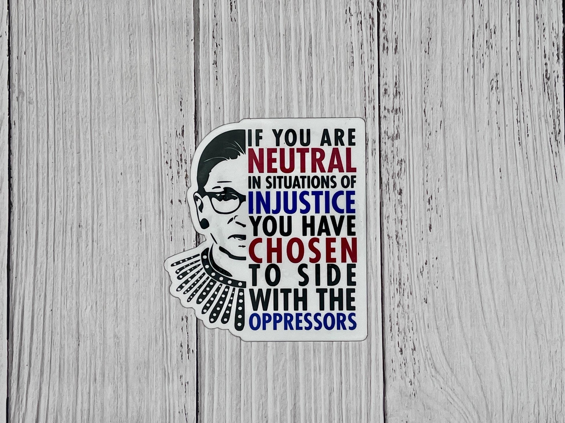 If you are neutral in situations of injustice, you have chosen to side with the oppressor magnet displayed on a table promoting action over silence