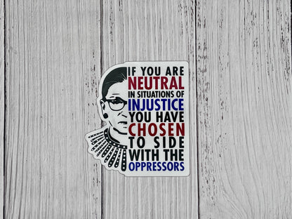 If you are neutral in situations of injustice, you have chosen to side with the oppressor magnet displayed on a table promoting action over silence