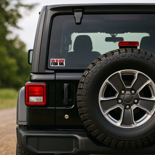 Black Jeep Wrangler with spare tire and 'No Blood for Oil' decal on a blurred natural background