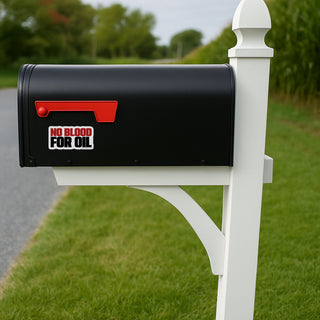 Black mailbox with 'No Blood for Oil' sticker on a white post in a grassy area.