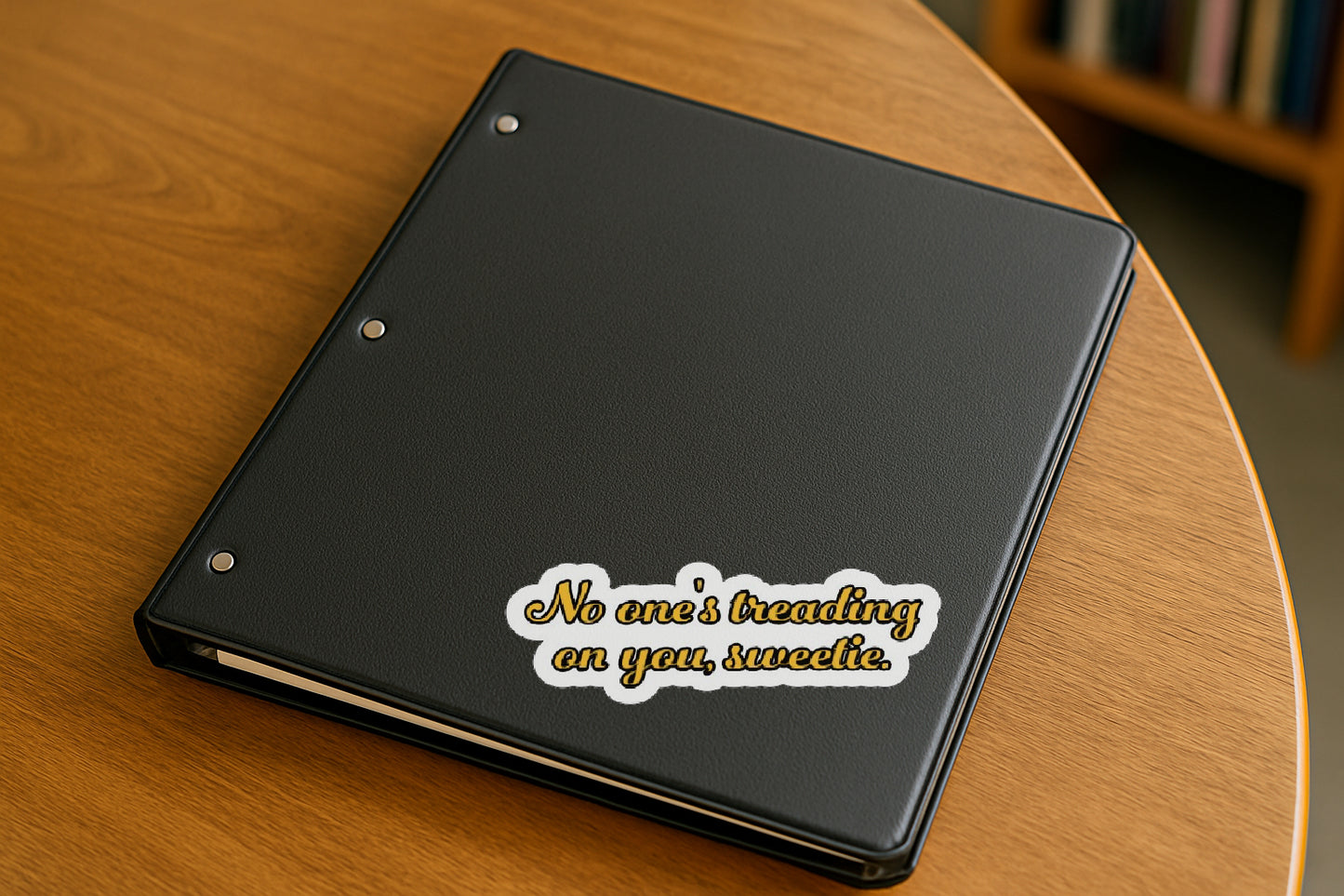 No One's Treading on you Sweetie' magnet or vinyl decal displayed on a black binder in a library. A bold, high-quality political sticker perfect for cars, laptops, fridges, or toolboxes. Great for activists, protestors, or anyone fed up with fascism.