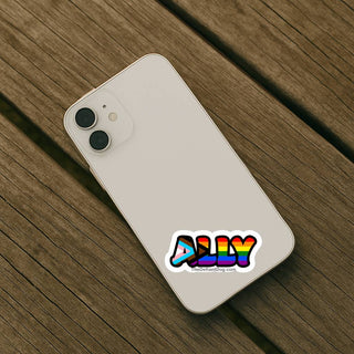 Progress pride “ALLY” sticker applied to the back of a light-colored smartphone