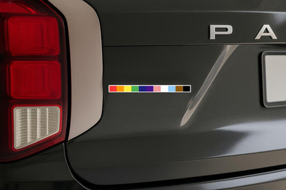 a magnet featuring the colors of the progress gay pride flag on back of suv
