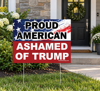 Proud American Ashamed of Trump political yard sign displayed in front of a home with patriotic anti-Trump message and metal stakes.