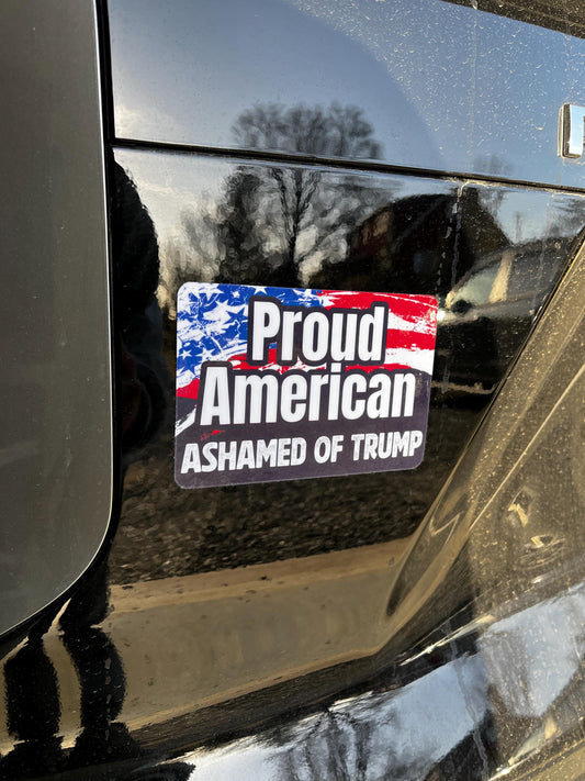 Proud American Ashamed of Trump magnet on the back of a car, expressing patriotism and political dissent.