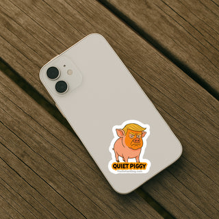 Phone case with 'Quiet Piggy' sticker on a wooden surface