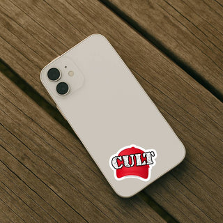 Phone case with 'CULT' logo on a wooden surface