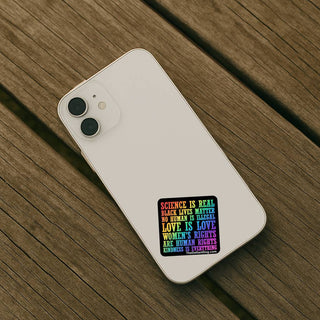 Phone case with a colorful text design on a wooden surface