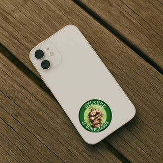 White phone with a green sticker on a wooden surface