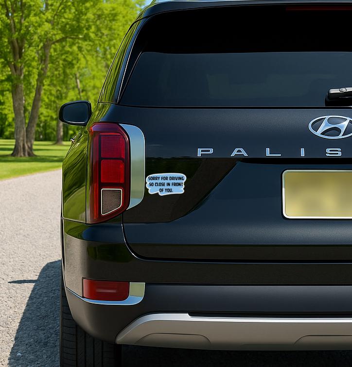 Blue and black sticker that says “Sorry for Driving So Close in Front of You” in bold text.