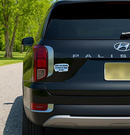 Blue and black sticker that says “Sorry for Driving So Close in Front of You” in bold text.