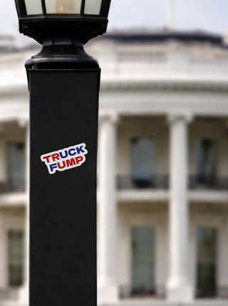 Truck Fump anti Trump vinyl sticker on black lamp post with White House background, political parody bumper sticker, anti Trump protest decal, liberal activist outdoor waterproof sticker
