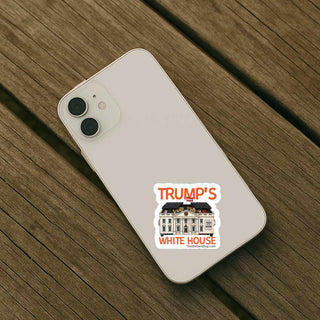 Phone with a sticker of 'Trump's White House' on a wooden surface