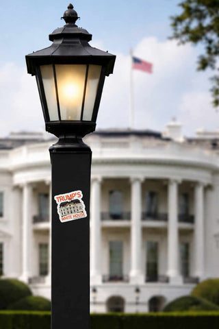 Lamp post with a 'Trump's America' sticker in front of the White House.