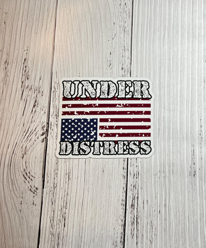 Under Distress magnet displayed on a table with an upside-down American flag, signaling a call for action in defense of democracy.