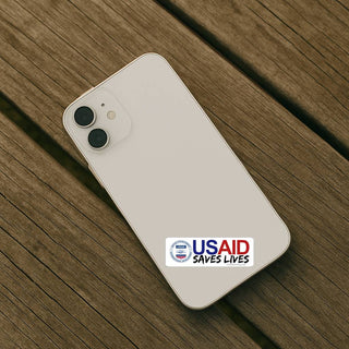 Phone with USAID logo on a wooden surface