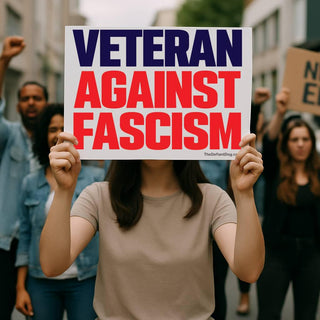 Person holding a Veteran Against Fascism protest sign during an outdoor political demonstration.