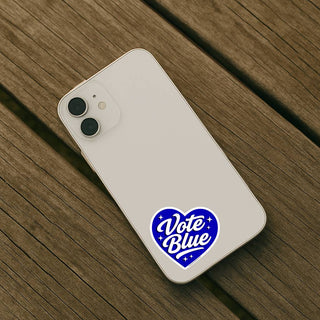 Phone with 'Vote Blue' sticker on a wooden surface