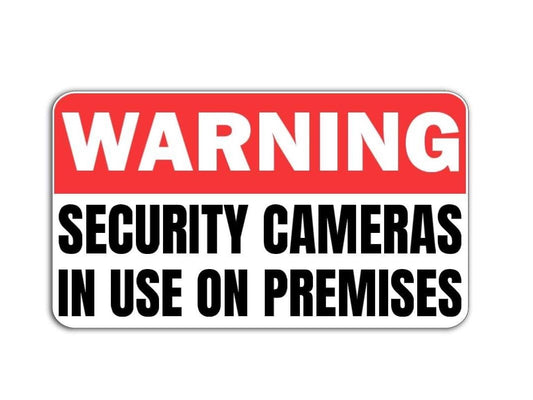 'Warning Security Cameras in Use' magnet or vinyl decal displayed with a slight shadow on a white background. 