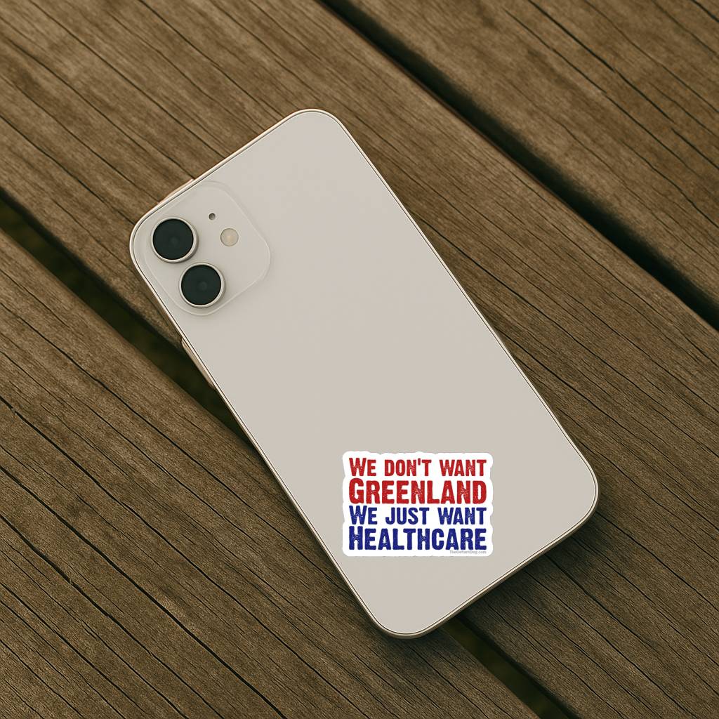 Phone case with text 'WE DON'T WANT GREENLAND WE JUST WANT HEALTHCARE' on a wooden surface