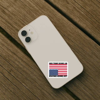 Sticker reading “When tyranny becomes law, resistance becomes duty” on the back of a light-colored smartphone